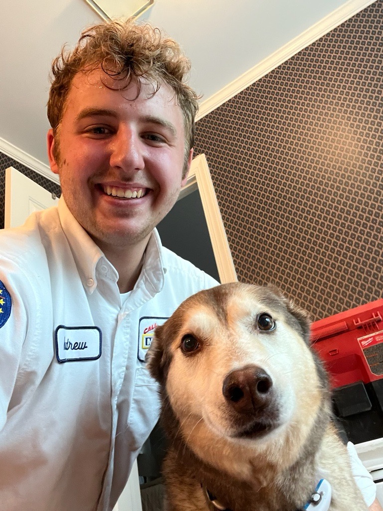 Technician smiling with dog
