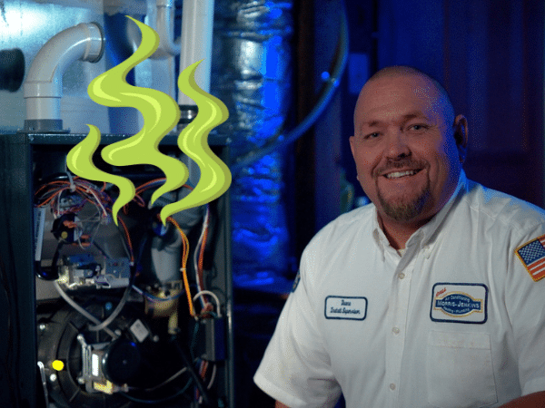 Technician next to an furnace with green odor graphic coming from the system