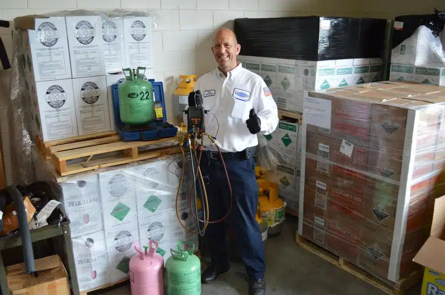 Tech testing refrigerant giving thumb's up