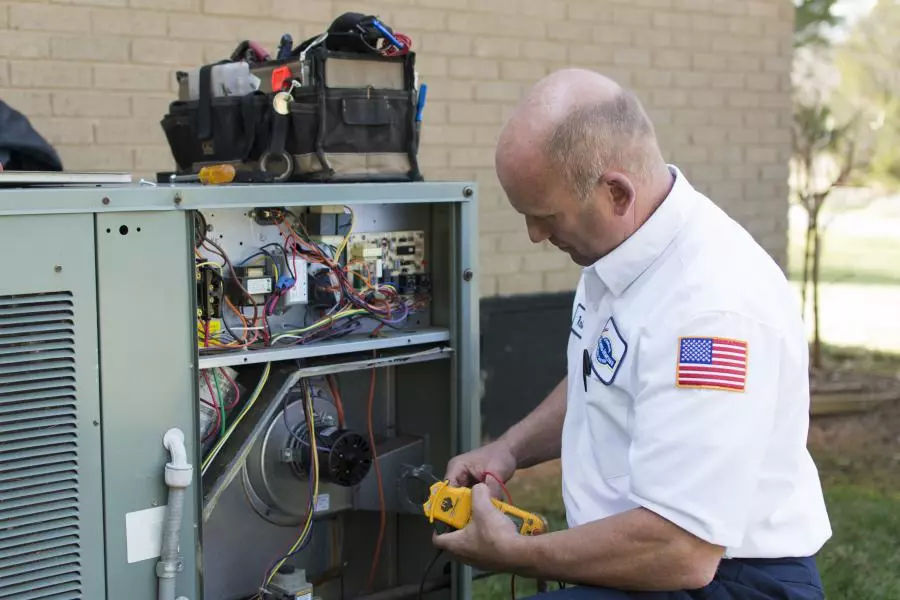 Technician working on heat pump