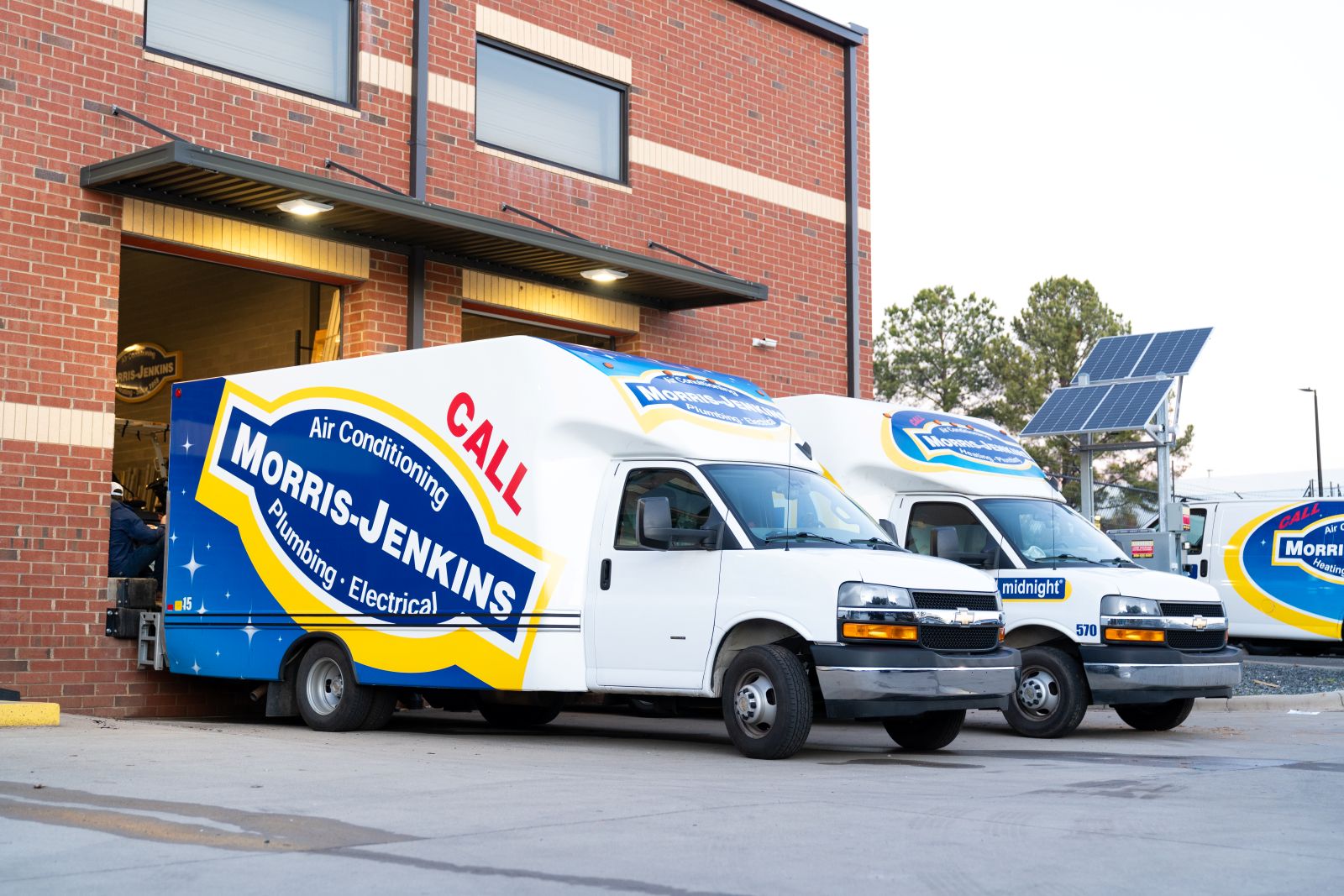 A photo of Moris-Jenkins service vehicles parked in the warehouse bay