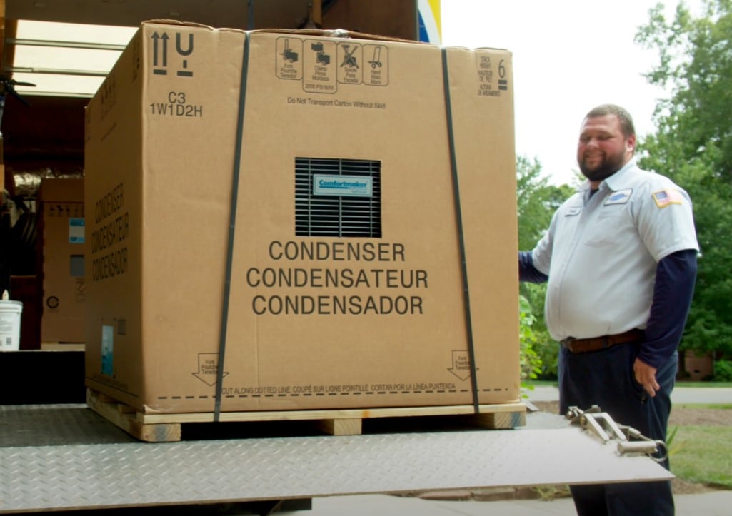 Tech unloading consdensor from truck