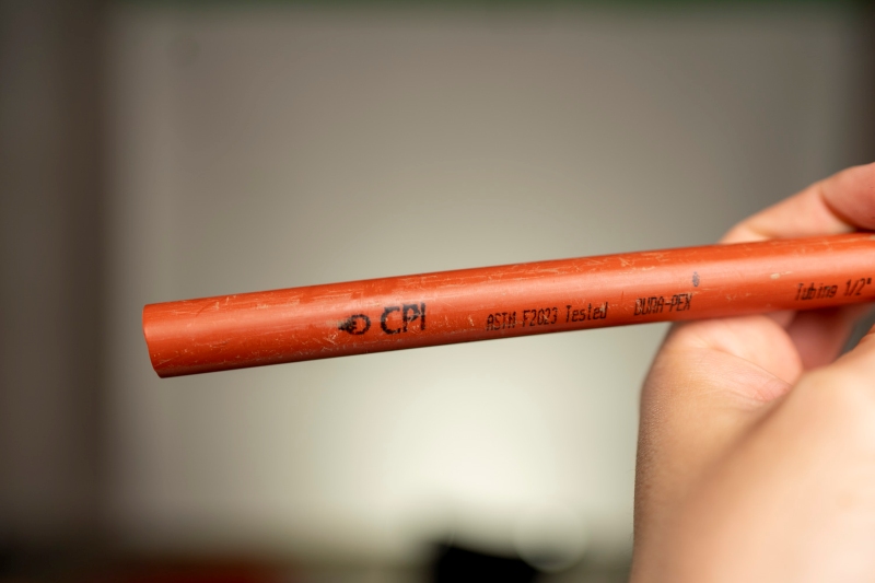 A tech displaying a dura pex pipe