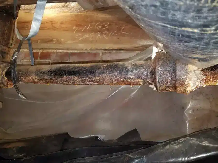 A pipe that has been damaged in a basement.