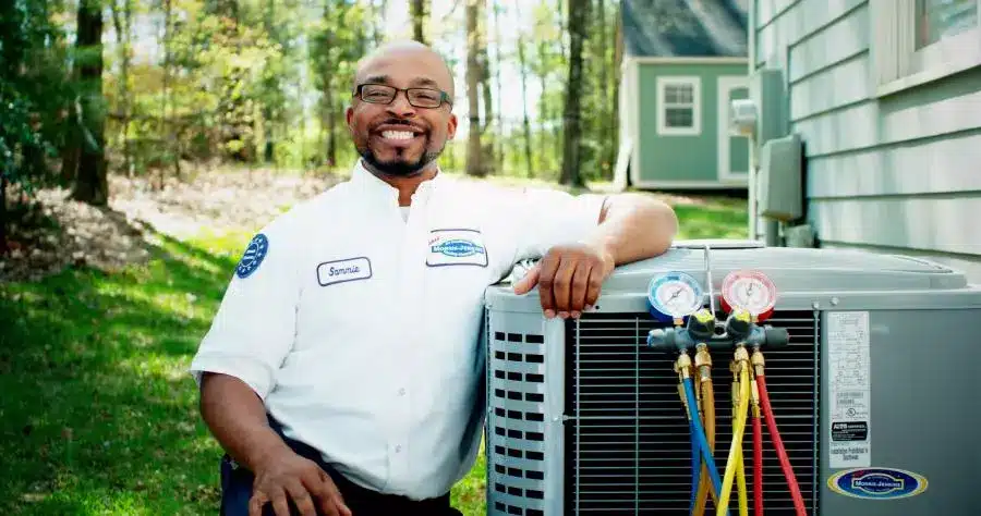 Morris-Jenkins technician standing next to an air conditioner
