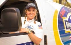 A woman sitting in the driver's seat of a van.