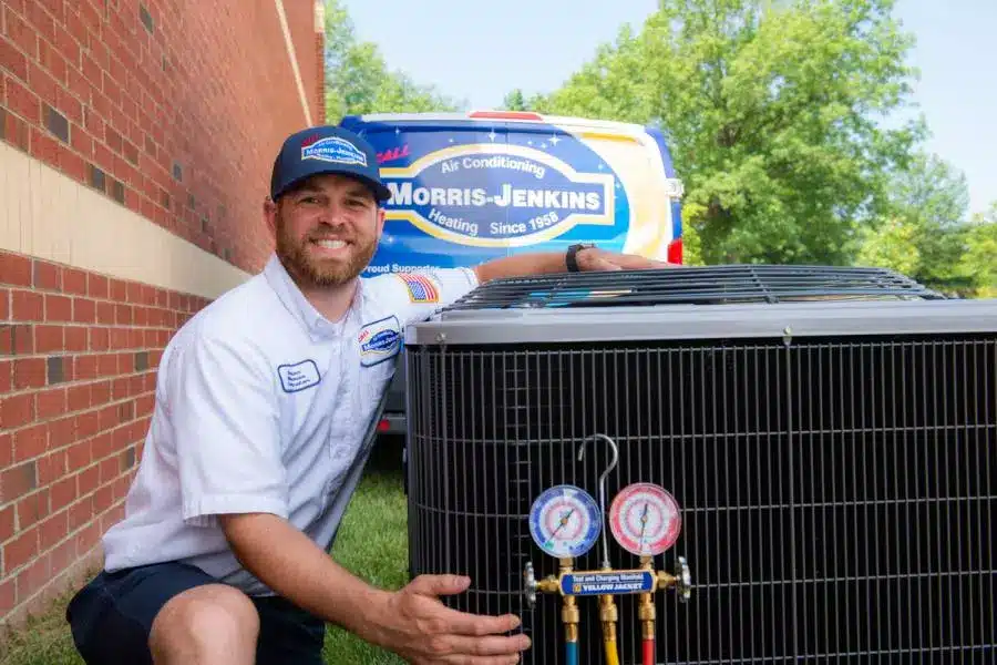 Morris-Jenkins technician standing next to an air conditioner