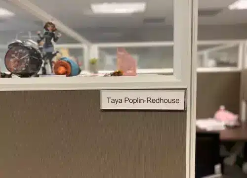 A cubicle with a lot of toys in it.