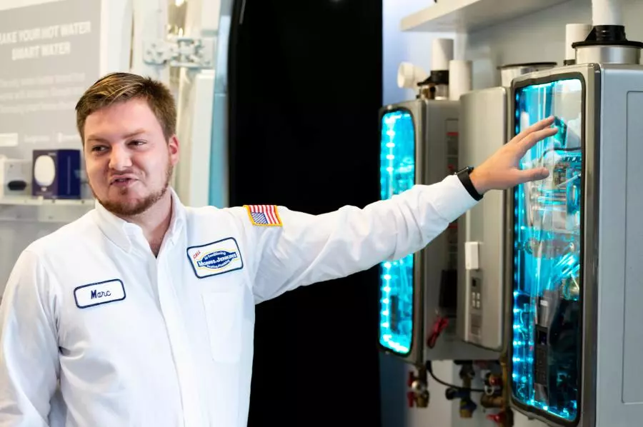 Morris-Jenkins tech standing next to a water heater