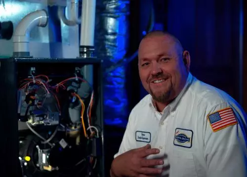 A man standing in front of a furnace.