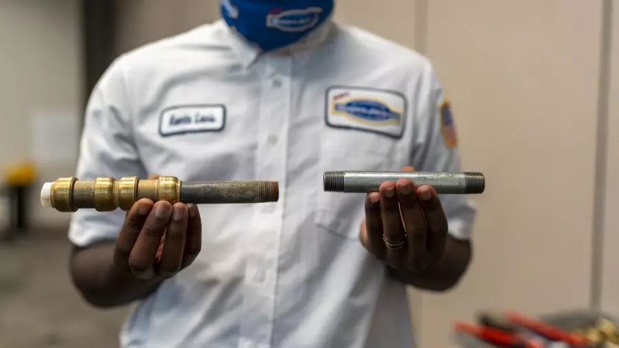 Technician Holding a Copper Pipe