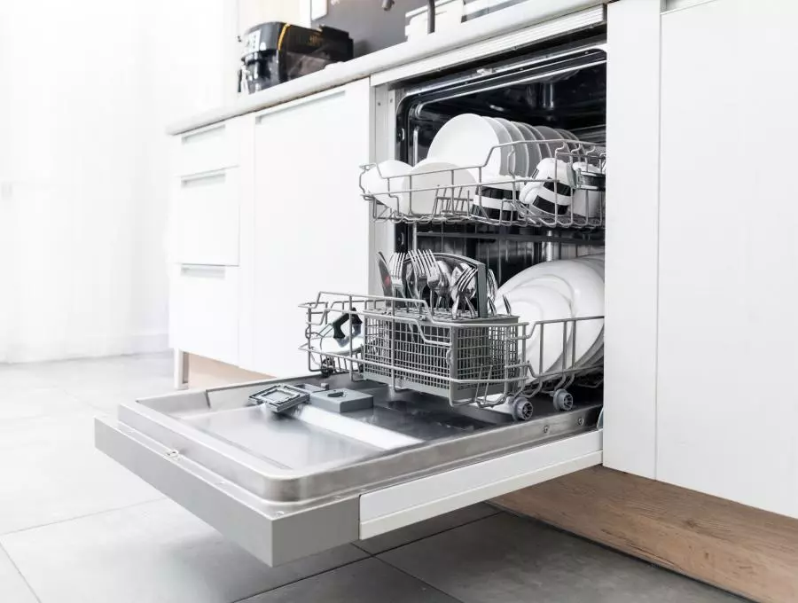 A dishwasher is open in a kitchen.