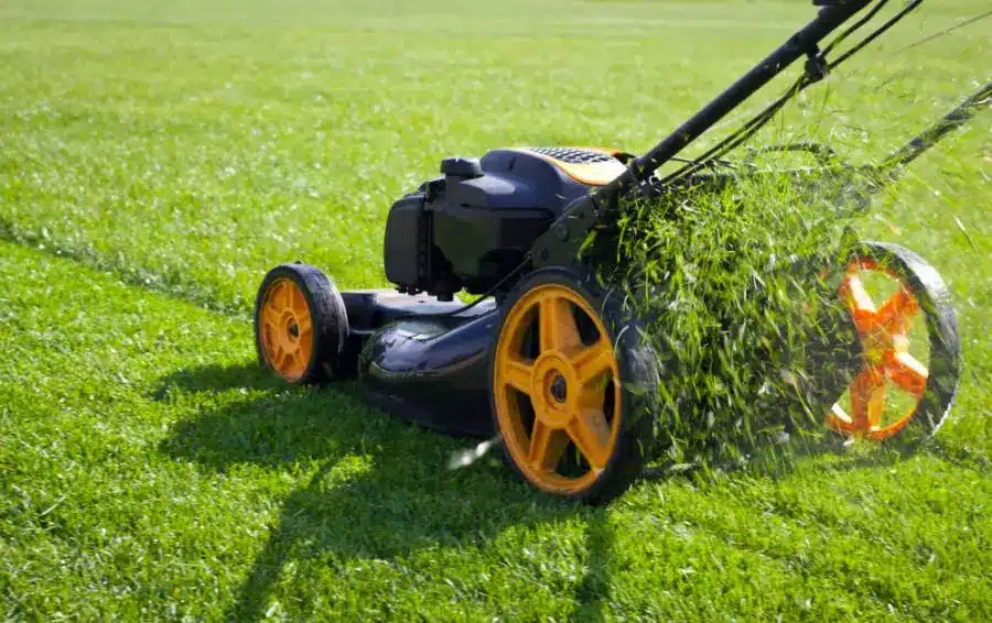 A lawn mower is being used to mow the grass.