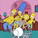 the TV show Simpsons family sitting on the couch in front of a fan.
