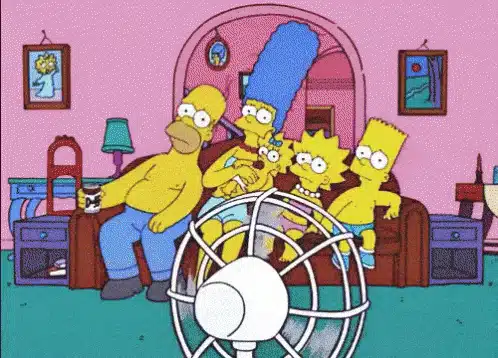 The simpsons family sitting in front of a fan.