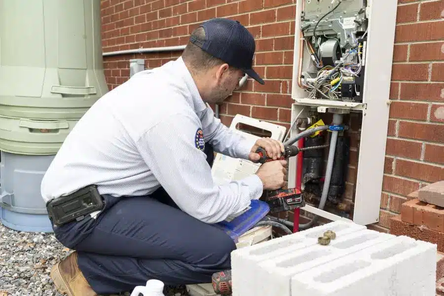 Morris-Jenkins technician working on a heating unit.