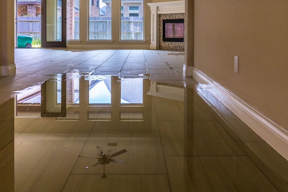 A house with a flooded floor and a fan.