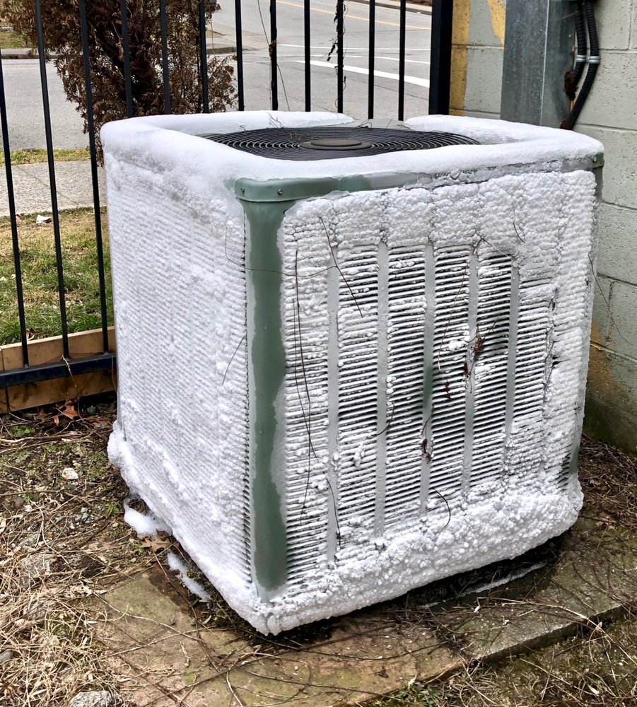 An air conditioner covered in snow.