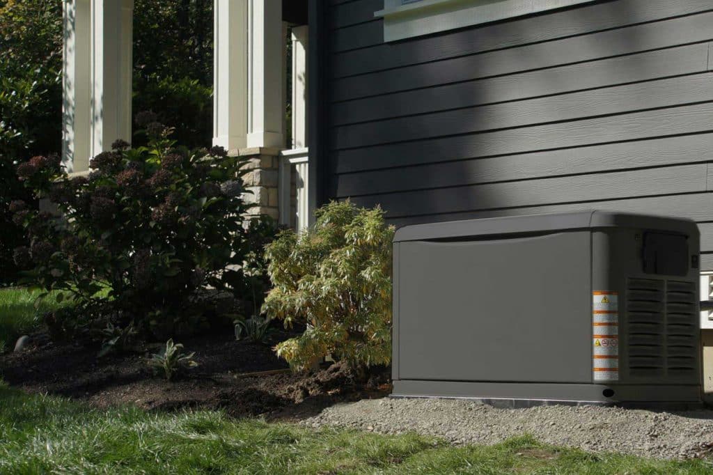 A generator in front of a house.