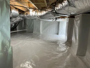 A room with a white floor and a plastic sheet covering the floor.
