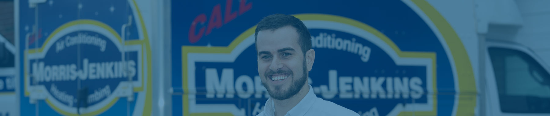 A man standing in front of a vehicle with "Morris Jenkins, Heating, Air Conditioning, and Plumbing" signage.